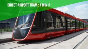a red train is parked at a train station at A 2 pas de la Mer - Climatisation - Wifi - Cuisine - Tramway in Nice +9 photos