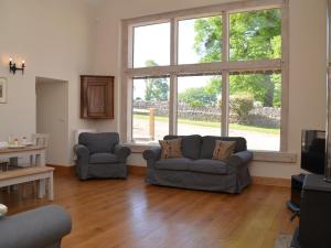 a living room with two couches and a large window at 3 Bed in Cheddar 58129 in Burrington +12 photos