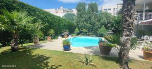 a swimming pool in a yard with trees and plants at Coup de coeur in Valence
