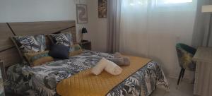 a bedroom with a bed with two pillows on it at Coup de coeur in Valence +6 photos