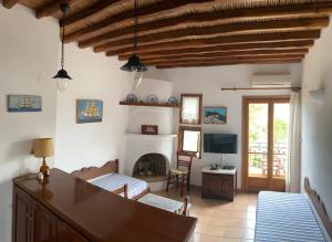 a living room with a table and a fireplace at Mealos Apartments in Skiros