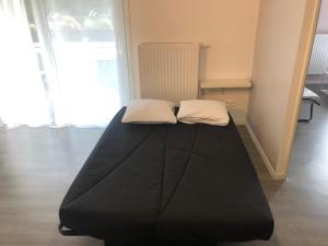 a bed with two pillows on it in a room at Appartement touristique Clisson gare in Clisson