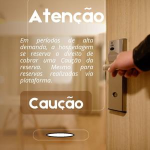 a person opening a door with a sign on it at Pousada Casa da Vovó - Sua casa pertinho da Praia in Aracaju