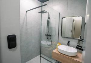 a bathroom with a sink and a glass shower at Exclusive 2-Bedroom Penthouse with Jacuzzi in Budapest +12 photos