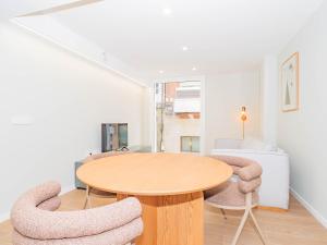 a dining room with a wooden table and chairs at YBH Atlantic Boutique in Vigo