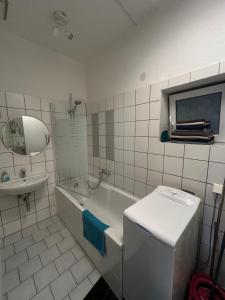 a bathroom with a sink and a tub and a toilet at Apartment Pension Sternchen in Erfurt +21 photos