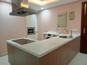 a kitchen with a sink and a counter top at Gold Crest Luxury Signature Serviced Hotel Apartments DHA Phase 4 Lahore in Lahore +46 photos