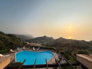 a pool with the sunset in the background at Villa Blue Horizon- Costa Paradiso in Costa Paradiso