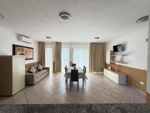 a living room with a table and a couch at Villa Blue Horizon- Costa Paradiso in Costa Paradiso