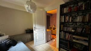 a living room with a door open to a room with a couch at La Grange au beau milieu des Pins in Lacanau