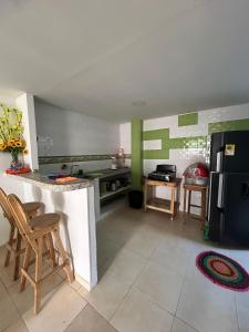 a kitchen with green and white stripes on the walls at Encantadora casa guajira 1 in Barranquilla