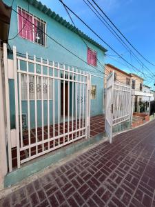 a blue house with a gate in front of it at Encantadora casa guajira 1 in Barranquilla
