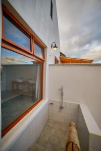 a bathroom with a large window and a shower at Tarangire Luxury Hideaway in Mbesi