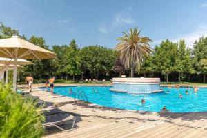 a large swimming pool with people in it at Camping Alannia El Pinar in Blanes