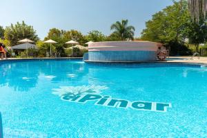 a large blue swimming pool with a sign on it at Camping Alannia El Pinar in Blanes