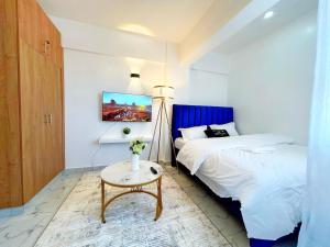 a small bedroom with a bed and a table at Gushu bnb Homes in Ruiru