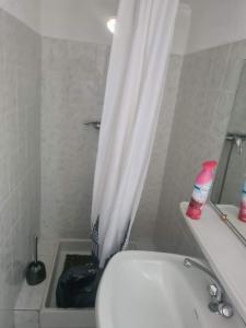 a bathroom with a toilet and a shower curtain at appartement indépendant CORTE in Corte