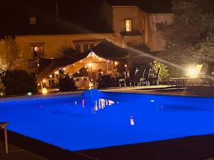 a pool with blue lighting in front of a house at Domaine Du Castellas in Saint-Raphaël +5 photos