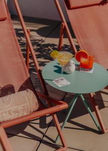 a drink sitting on a table next to a chair at Vincci Molviedro in Seville +66 photos