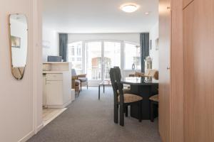 a living room with a table and a dining room at LECOMTE - Beachside 154 in Ostend