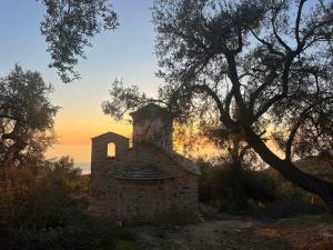 an old stone church sitting on top of a hill at Seaside Soul -Cozy Escape Apartment in Lukovë