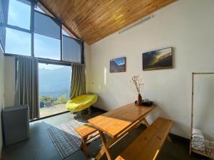 a room with a wooden table and a large window at 1579 Sa Pa in Sapa