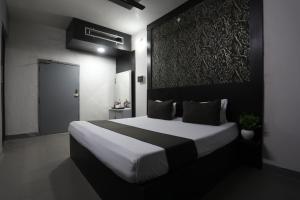 a bedroom with a large bed in a room at Jashn inn in Jabalpur