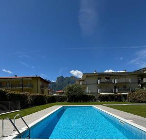 a swimming pool in front of a building at Garden & Pool Perugini in Nago-Torbole