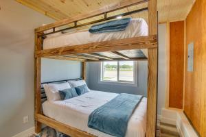a bedroom with two bunk beds in a house at Garden City Home with Fire Pit Walk to Bear Lake! in Garden City