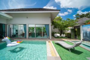 a swimming pool in a villa with a pool house at Bang tao modern holiday style pool view high speed WiFi in Laguna Phuket