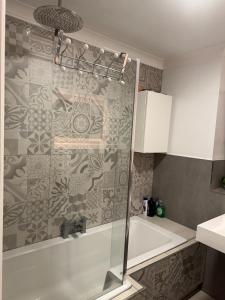 a bathroom with a shower with a glass door at This guest house not ready please don t book me in Glasgow