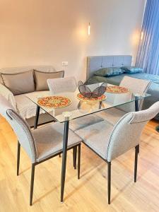 a table with chairs and a couch in a living room at Bamboo 754 in Ts'ikhisdziri