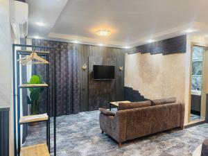 a living room with a couch and a tv at Tikir House in Pamukkale