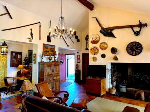 a living room with a couch and a fireplace at Monte da Casa Telhada in Santiago do Cacém