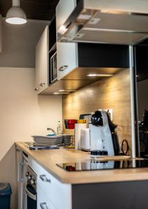 a kitchen with a counter with a appliance on it at Agréable cocon sous les toits - Parking - WiFi in Pléneuf-Val-André +11 photos
