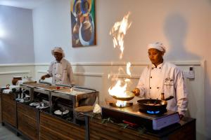 two chefs standing in a kitchen preparing food at Tarangire Luxury Hideaway in Mbesi +99 photos