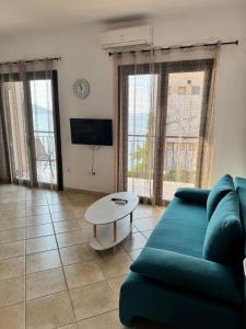 a living room with a couch and a table at Alexis Apartments in Pylos