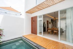 a house with a swimming pool and a dining room at Sunrise Bliss 2 in Dalung