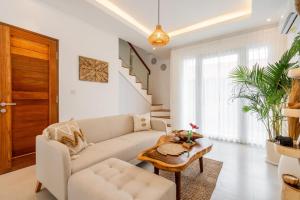 a living room with a couch and a table at Sunrise Bliss 2 in Dalung