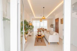 a living room with a white couch and a table at Sunrise Bliss 2 in Dalung +69 photos