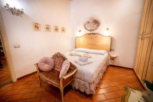 a bedroom with a large bed and a chair at Ricale in Florence