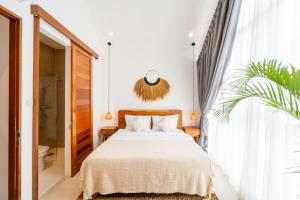 a bedroom with a bed and a large window at Sunrise Bliss 2 in Dalung