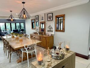 a dining room with a wooden table and chairs at Zimbali Coastal Resort Yellowwood House in Ballito