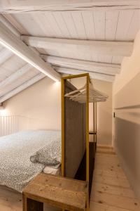 a bedroom with a bed and a mirror at La casa della Maestra Carolina in Ottiglio
