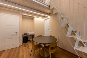 a room with a table and chairs and a staircase at La casa della Maestra Carolina in Ottiglio +34 photos