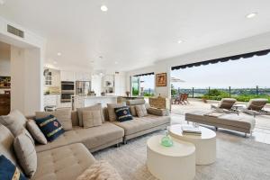 a living room with a couch and a table at Exquisite Panoramic View Estate in Newport Beach