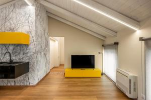 a living room with a flat screen tv on a wall at La casa della Maestra Carolina in Ottiglio
