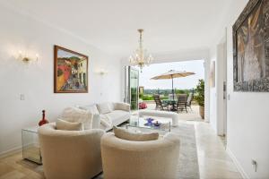 a living room with a couch and chairs and a table at Exquisite Panoramic View Estate in Newport Beach