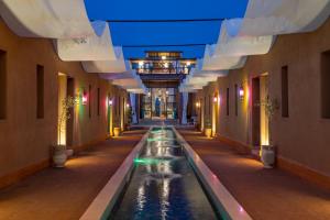 a hallway with a pool in a building at Al destino Resort Marrakech in Marrakesh