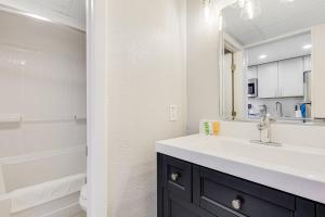 a bathroom with a sink and a mirror at Playa Poesia By Casanita - Oceanfront Lux Studio in Myrtle Beach +23 photos
